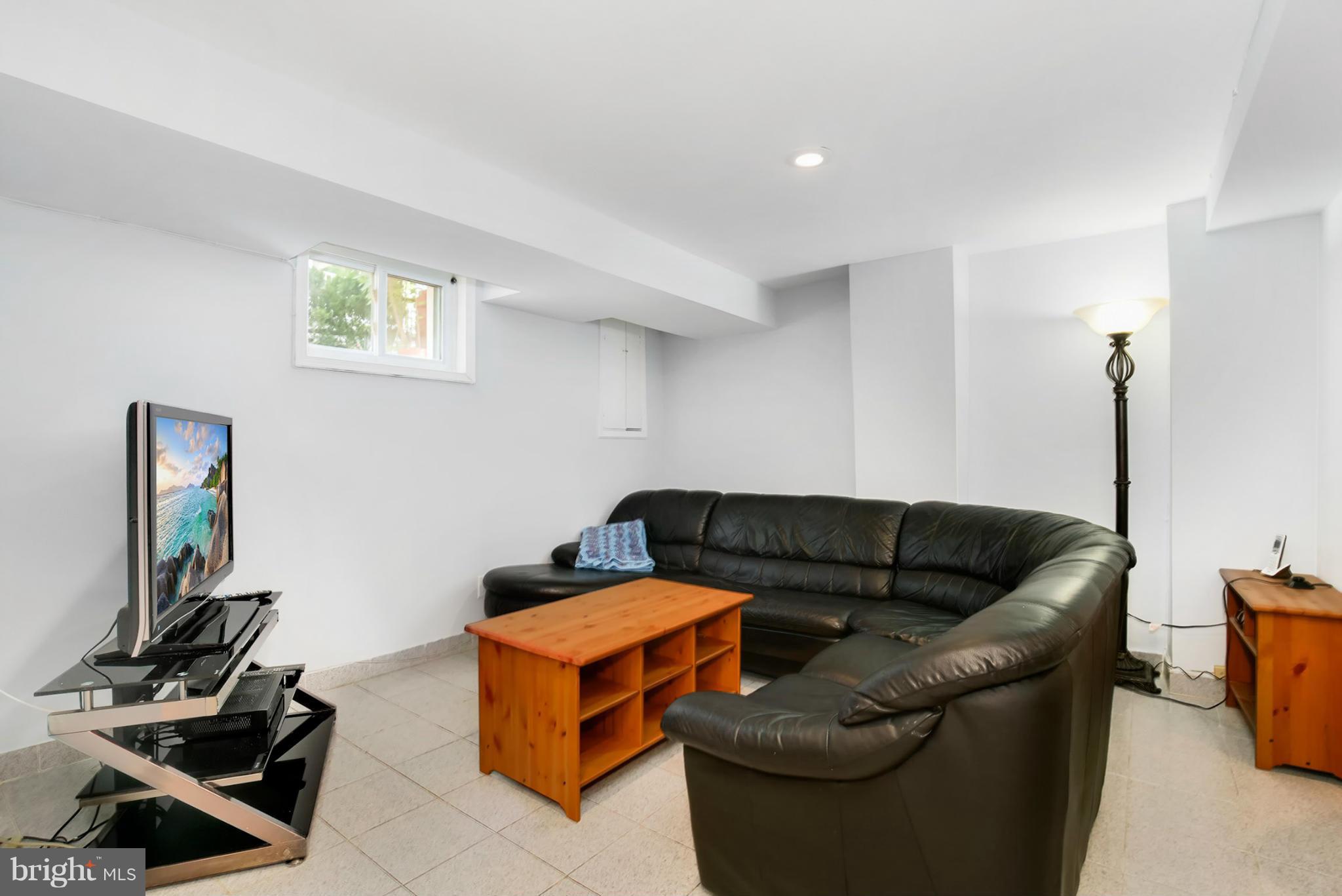 3835 Military Road Northwest Washington, DC 20015 - Photo 22 of 28 a living room with furniture and a flat screen tv
