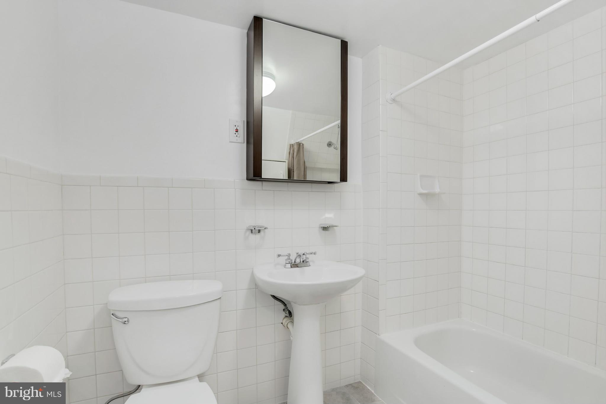 3835 Military Road Northwest Washington, DC 20015 - Photo 24 of 28 a bathroom with a sink toilet and shower