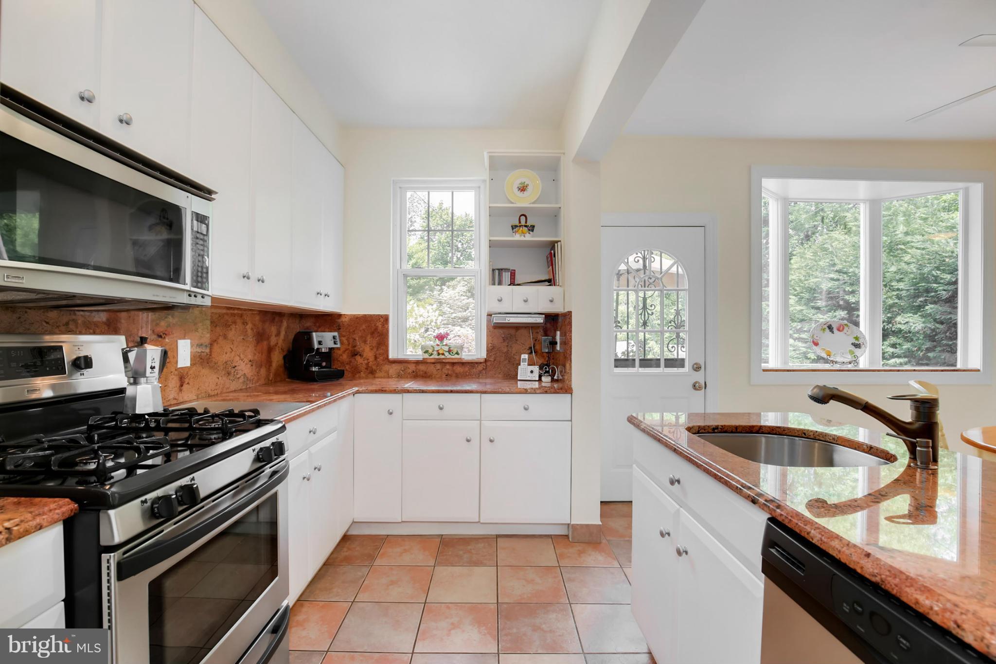 3835 Military Road Northwest Washington, DC 20015 - Photo 10 of 28 a kitchen with granite countertop a sink stove and cabinets