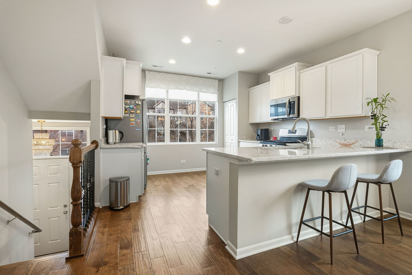 8536 Grove Street Morton Grove, IL 60053 - Photo 11 of 26 a kitchen with a table chairs refrigerator and cabinets