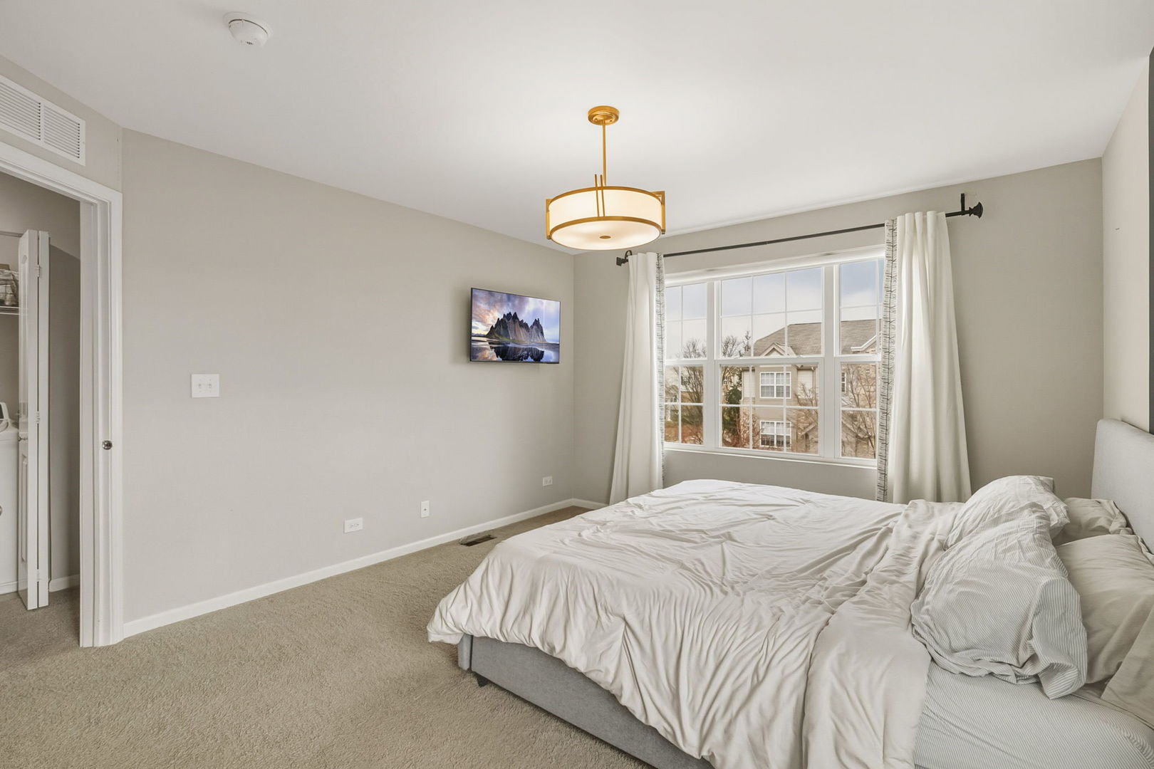 8536 Grove Street Morton Grove, IL 60053 - Photo 16 of 26 a bedroom with a large bed and a window