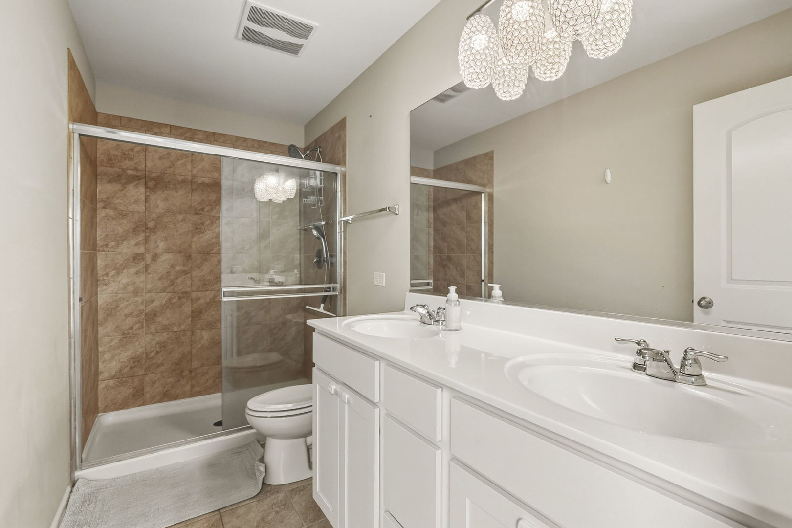 8536 Grove Street Morton Grove, IL 60053 - Photo 17 of 26 a bathroom with a granite countertop sink a toilet and shower