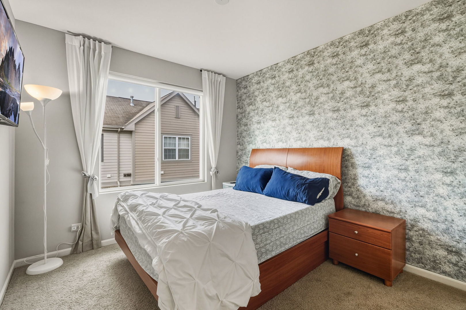 8536 Grove Street Morton Grove, IL 60053 - Photo 18 of 26 a bedroom with a bed and a window