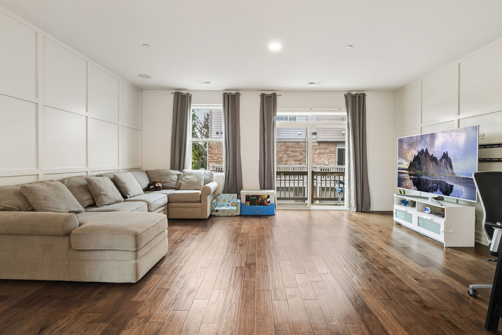 8536 Grove Street Morton Grove, IL 60053 - Photo 2 of 26 a living room with furniture and a flat screen tv