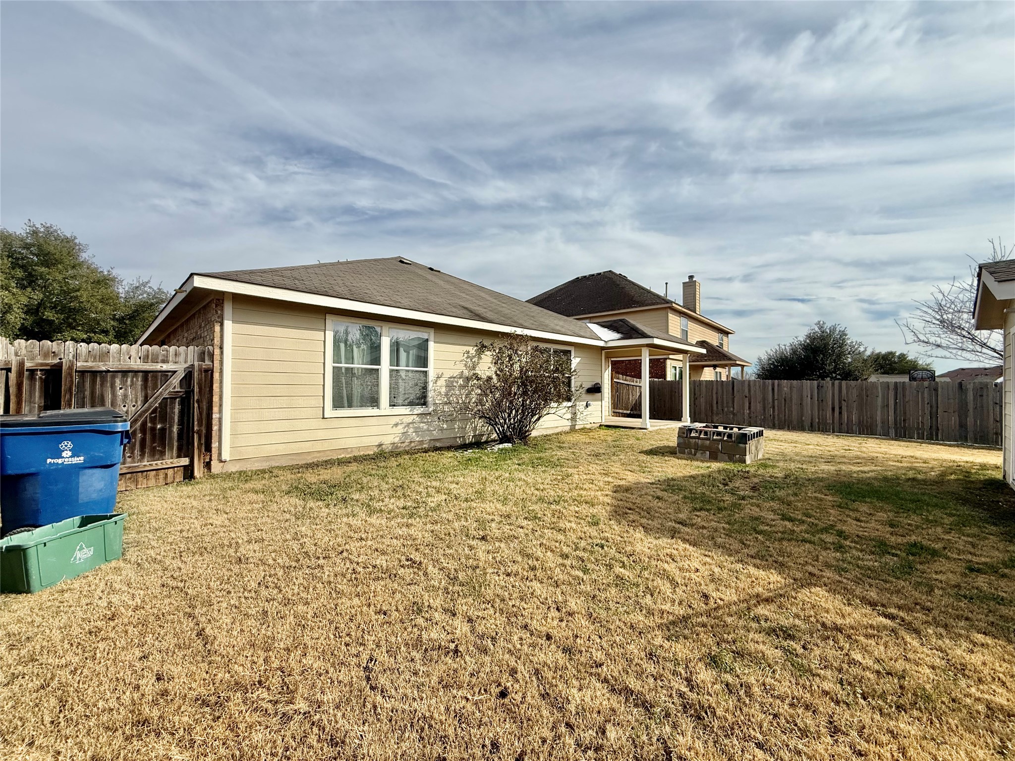 12820 Waynespur Lane Elgin, TX 78621 - Photo 24 of 26 Back of house with a patio and a fenced backyard