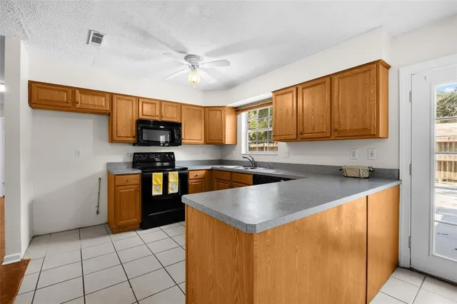 a kitchen with stainless steel appliances granite countertop a sink microwave and stove