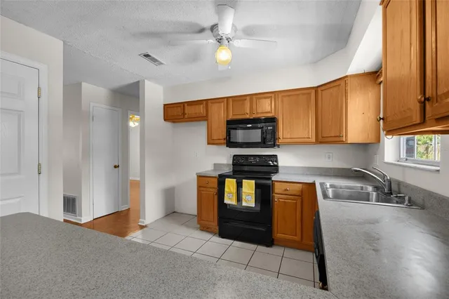 a kitchen with stainless steel appliances granite countertop a refrigerator and a stove top oven