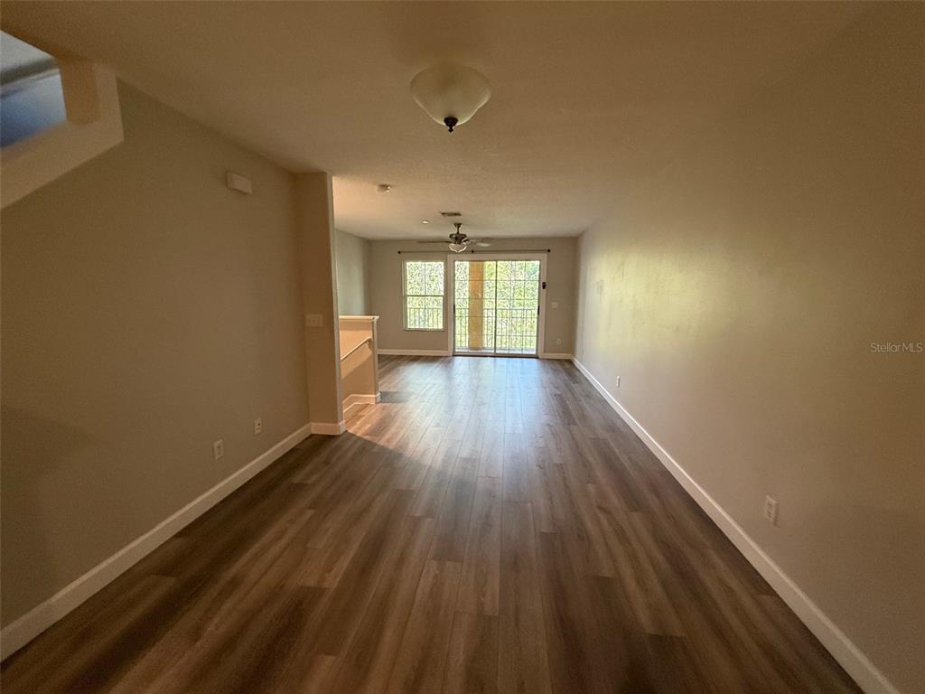 7350 Black Walnut Way Lakewood Ranch, FL 34202 - Photo 14 of 52 wooden floor in an empty room with a window