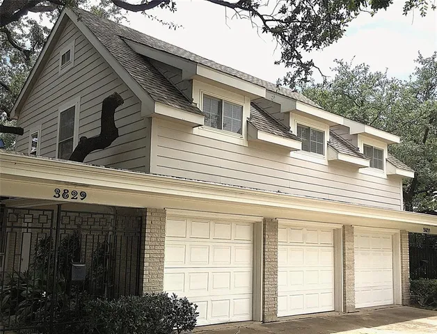 a view of a house with a garage and balcony