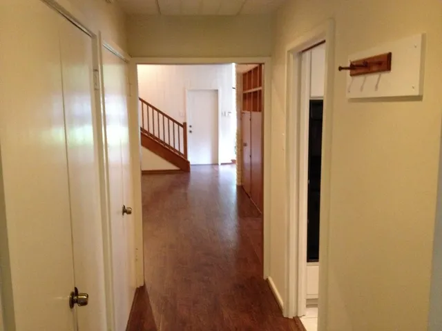 a view of a hallway with wooden floor