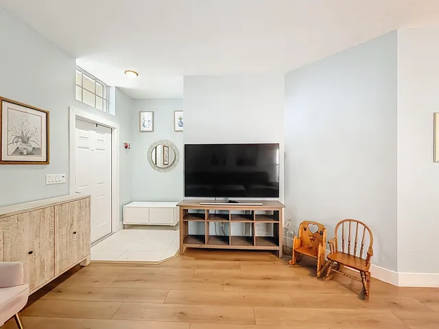 a kitchen with stainless steel appliances granite countertop a refrigerator a sink a stove a microwave a counter top and chairs