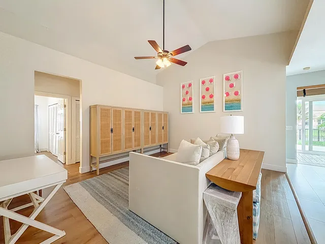 a kitchen with granite countertop a stove top oven microwave and refrigerator