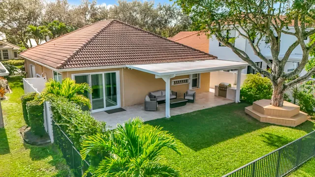 an aerial view of residential houses with outdoor space and trees