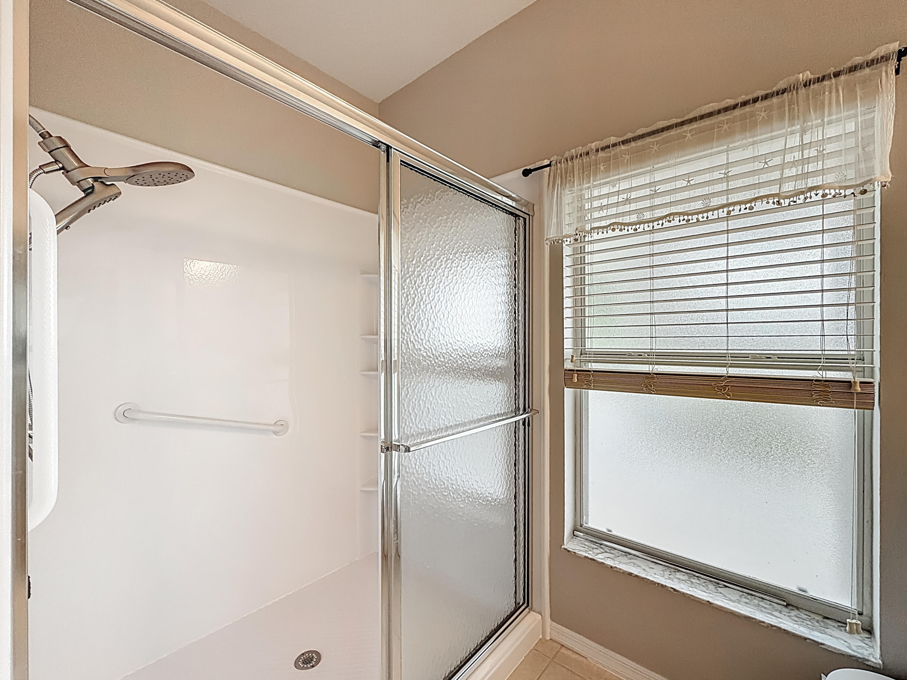 1143 Canoe Point Delray Beach, FL 33444 - Photo 43 of 85 a bathroom with a glass shower door