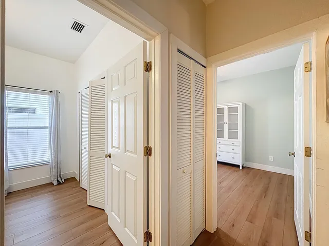 an aerial view of residential houses with outdoor space and trees