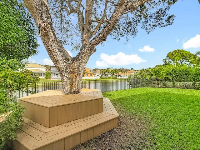 an aerial view of a house with a yard and lake view