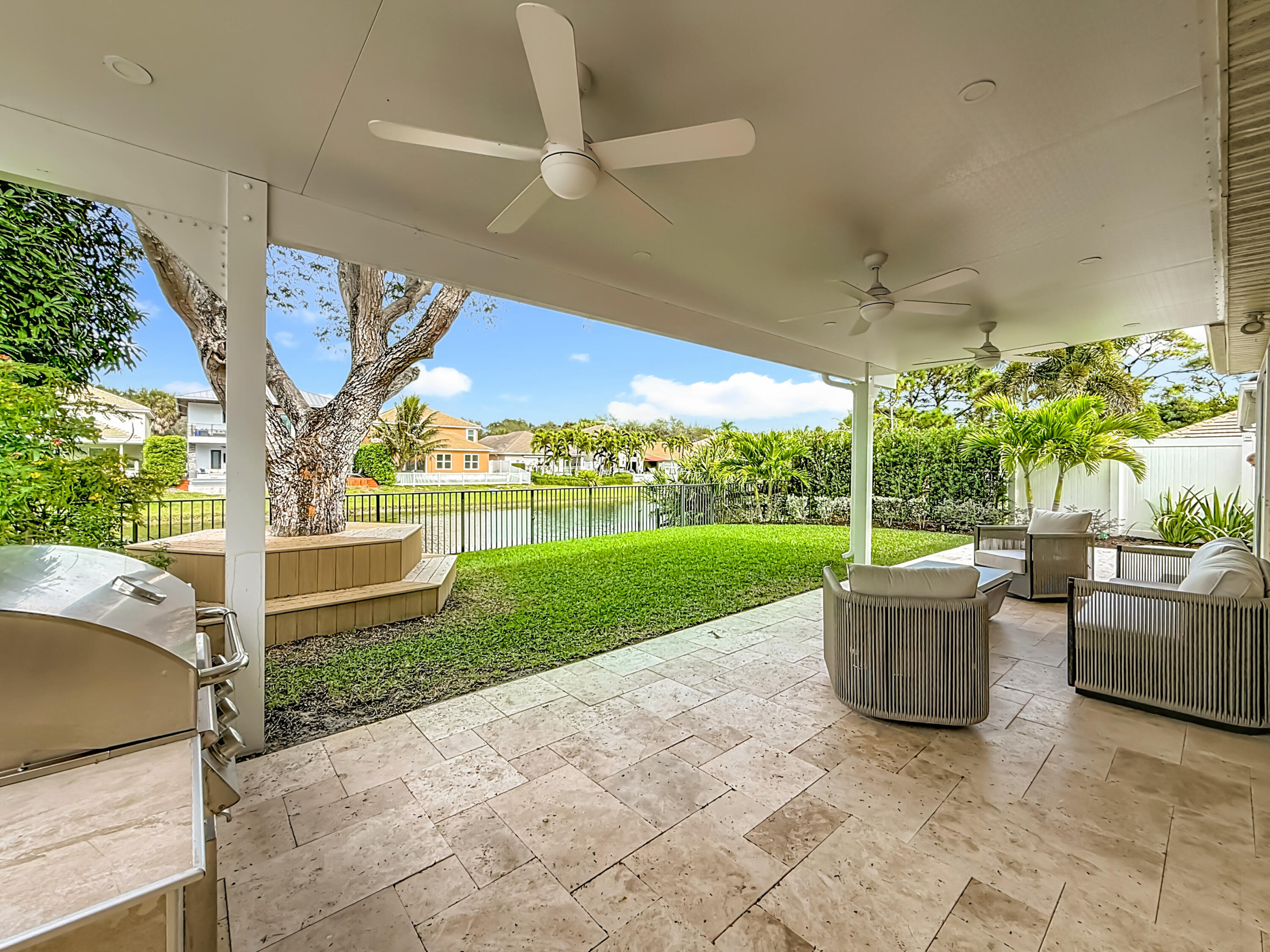 1143 Canoe Point Delray Beach, FL 33444 - Photo 56 of 85 a view of a patio with couches chairs potted plants and a big yard