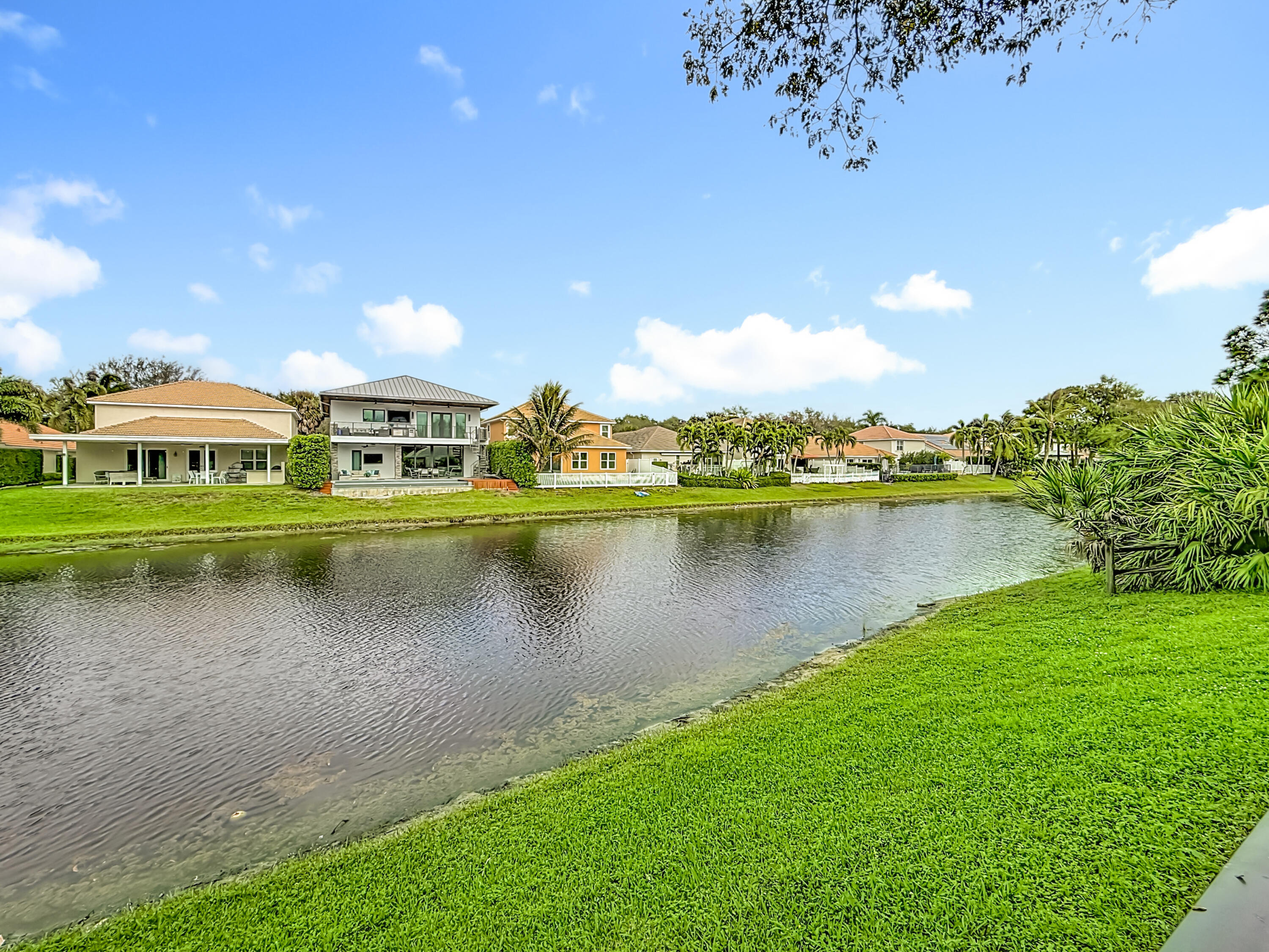 1143 Canoe Point Delray Beach, FL 33444 - Photo 72 of 85 a view of a lake with houses in the back