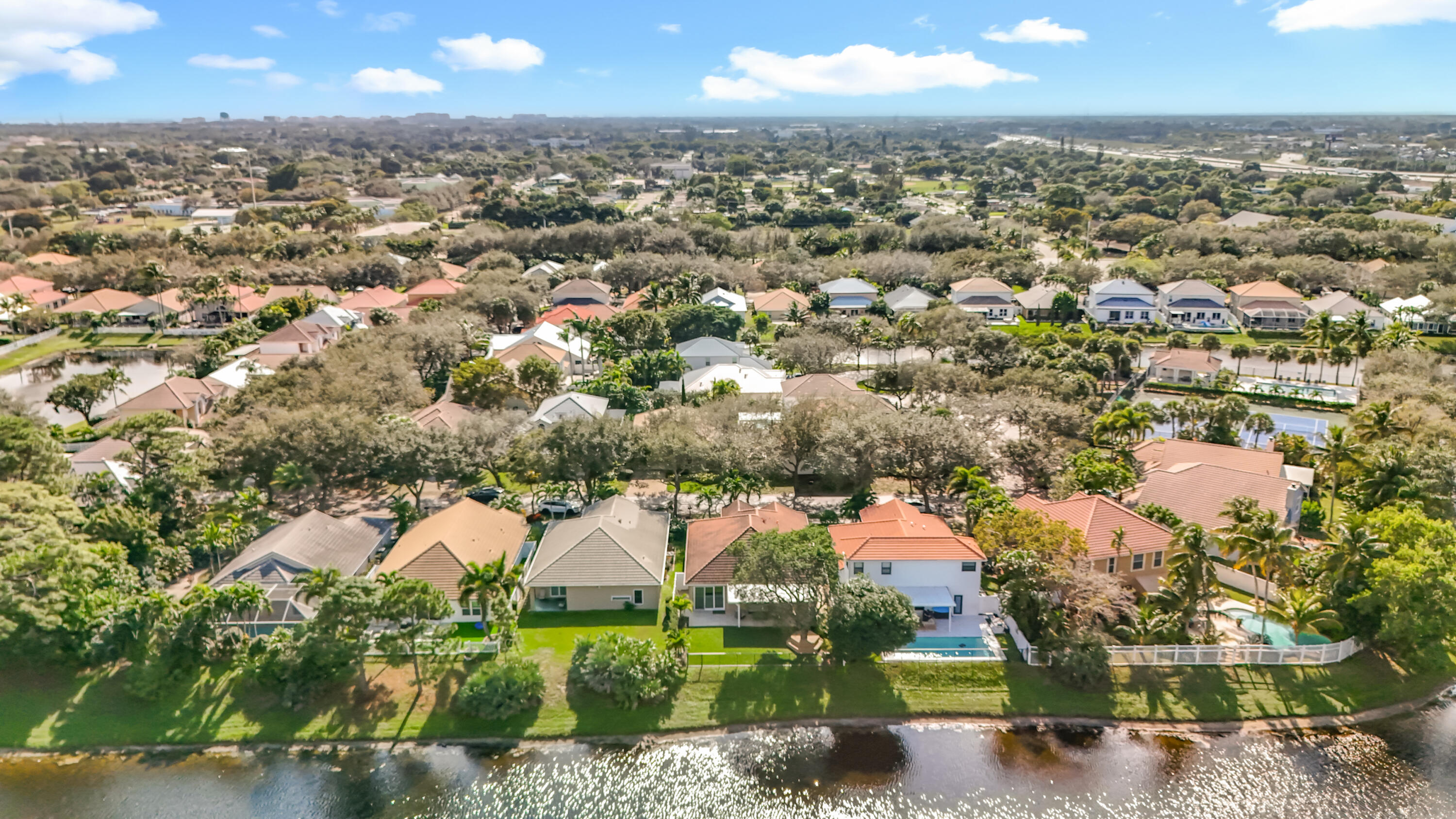 1143 Canoe Point Delray Beach, FL 33444 - Photo 78 of 85 an aerial view of residential houses with outdoor space and trees