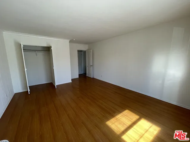 a view of an empty room and wooden floor