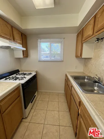 a kitchen with stainless steel appliances granite countertop a stove and a sink