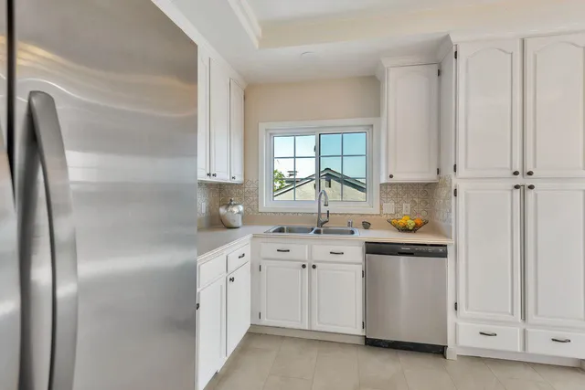 a view of hallway with a large window and wooden floor