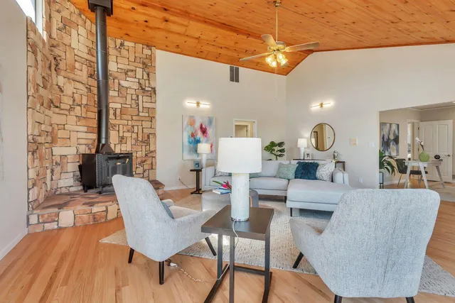 a bedroom with a bed and a lamp on dresser