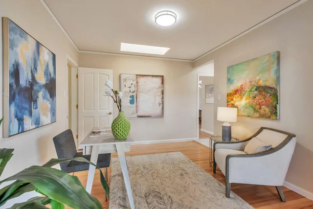 a white bath tub sitting next to a white sink and a vanity