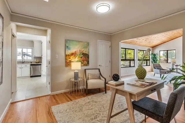 a living room with furniture and a dining table