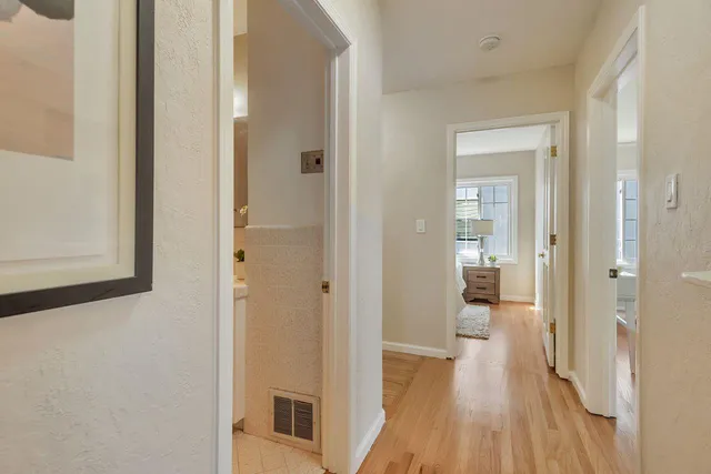 a view of a hallway with wooden walls