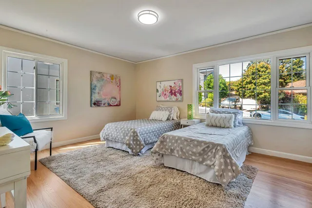 an aerial view of a house with a yard and a large tree