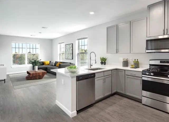 a kitchen with a sink cabinets and window