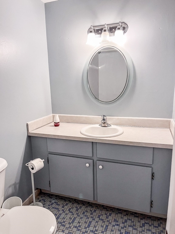 57 Will Drive, Unit 168 Canton, MA 02021 - Photo 11 of 15 a bathroom with a sink mirror and toilet