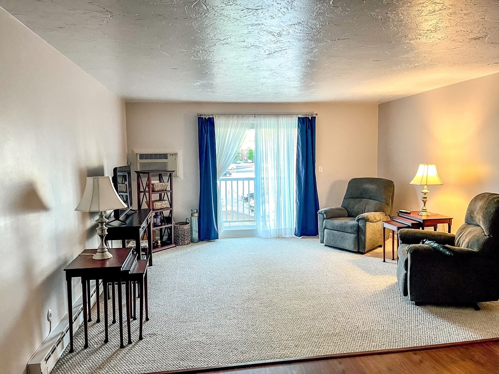 57 Will Drive, Unit 168 Canton, MA 02021 - Photo 3 of 15 a bedroom with furniture and a window