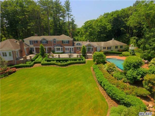 a aerial view of a house next to a big yard
