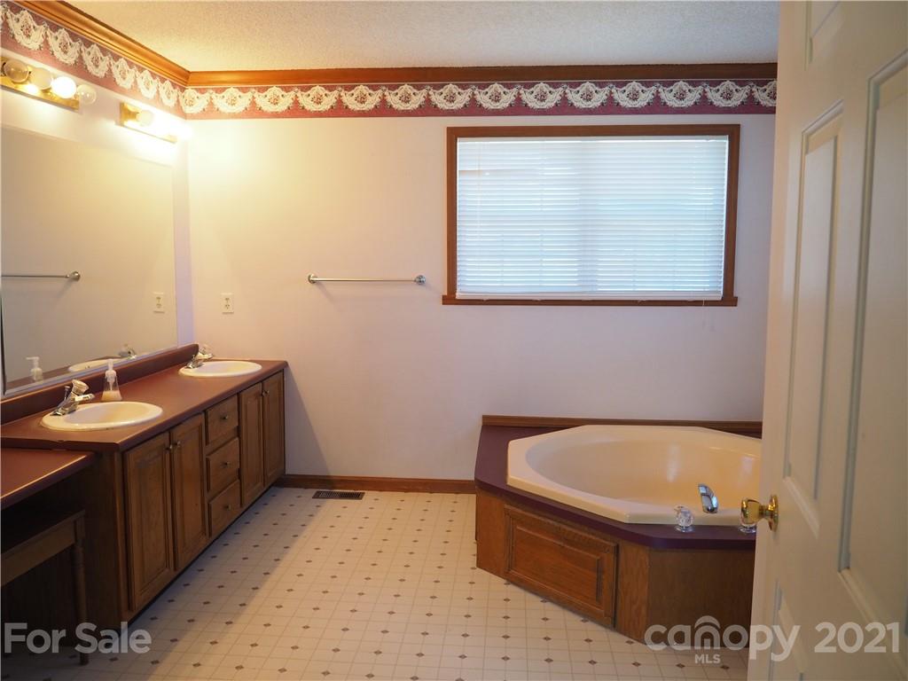 1201 Goldmine Road Chester, SC 29706 - Photo 8 of 30 a bathroom with a tub sink and mirror