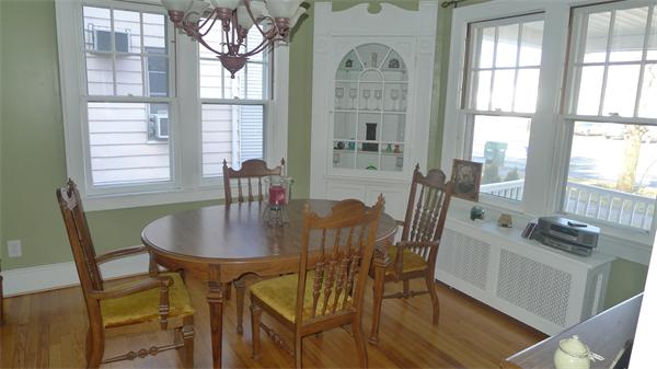 929 Sumner Avenue Springfield, MA 01118 - Photo 12 of 29 a dining room with furniture a chandelier and wooden floor