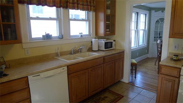 929 Sumner Avenue Springfield, MA 01118 - Photo 16 of 29 a kitchen with a sink window and cabinets