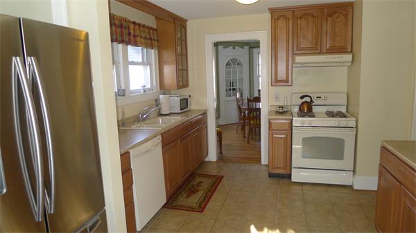 929 Sumner Avenue Springfield, MA 01118 - Photo 17 of 29 a kitchen with a sink a refrigerator and cabinets
