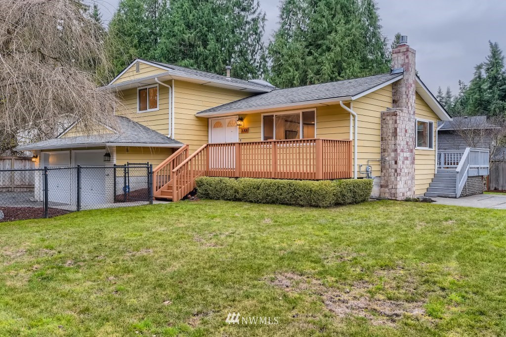 3301 198th Place Southeast Bothell, WA 98012 - Photo 1 of 35 a view of a yard in front of a house with plants and large tree