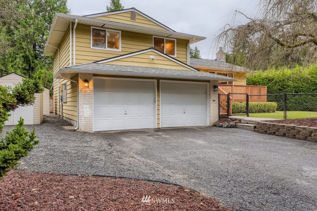 3301 198th Place Southeast Bothell, WA 98012 - Photo 2 of 35 a front view of a house with a yard and garage