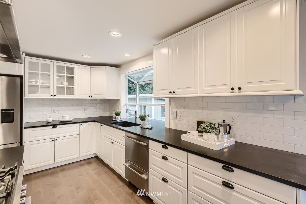 3301 198th Place Southeast Bothell, WA 98012 - Photo 11 of 35 a kitchen with granite countertop white cabinets and white appliances