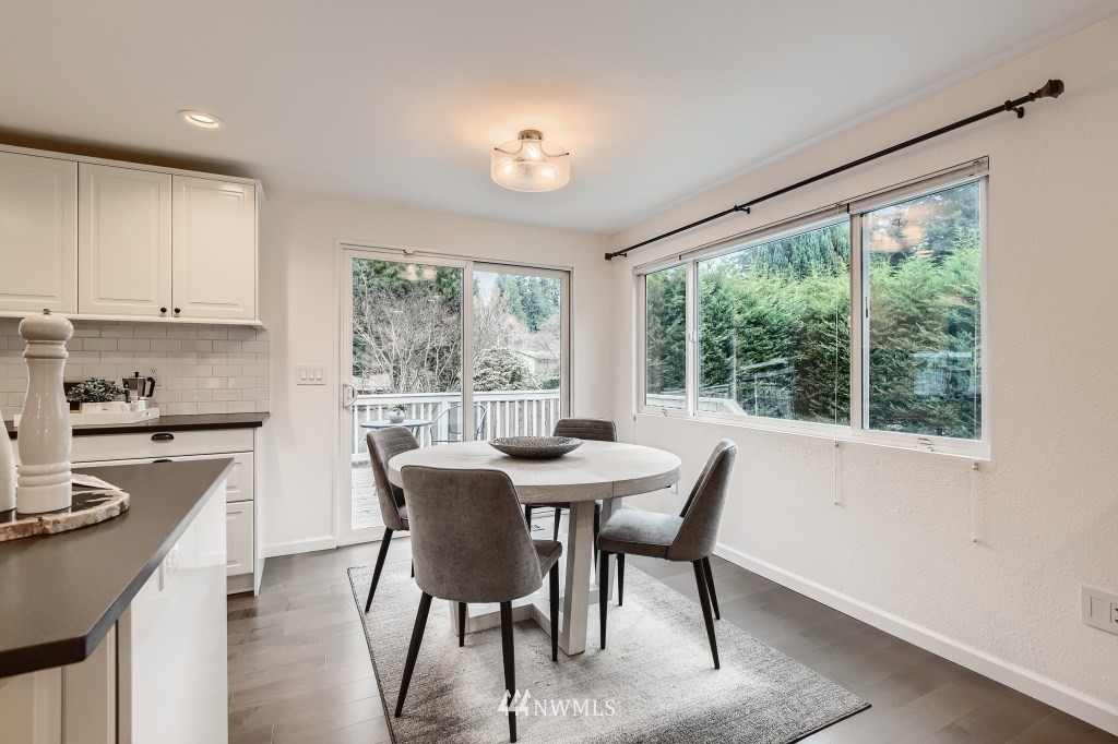 3301 198th Place Southeast Bothell, WA 98012 - Photo 12 of 35 a view of a dining room with furniture a chandelier and wooden floor