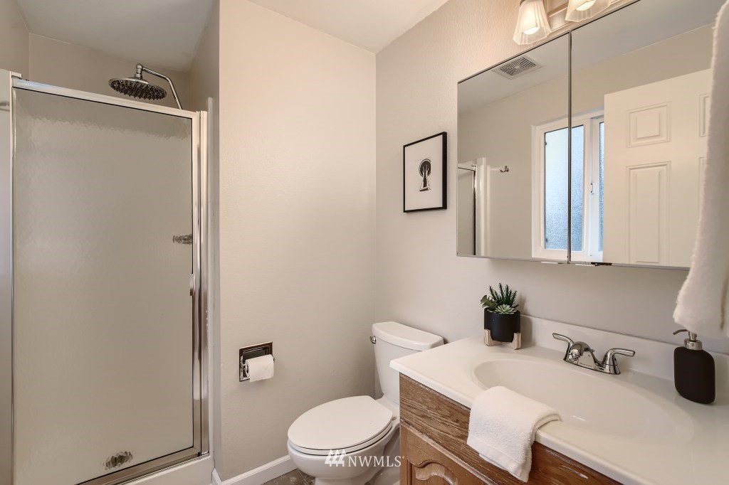 3301 198th Place Southeast Bothell, WA 98012 - Photo 14 of 35 a bathroom with a sink a toilet and shower curtain