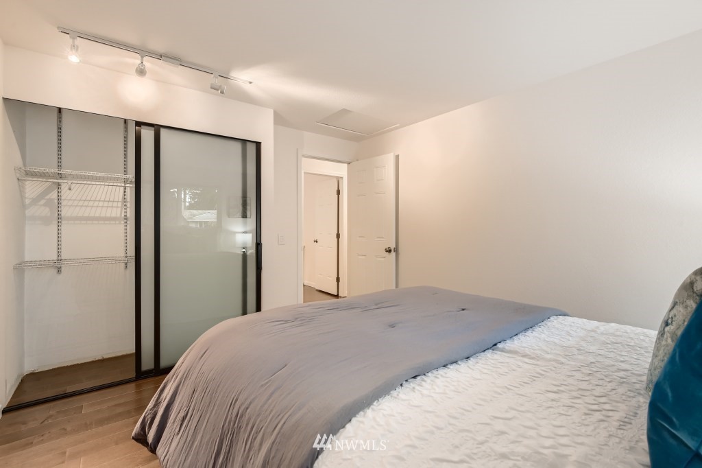 3301 198th Place Southeast Bothell, WA 98012 - Photo 19 of 35 a bedroom with a large bed and wooden floor