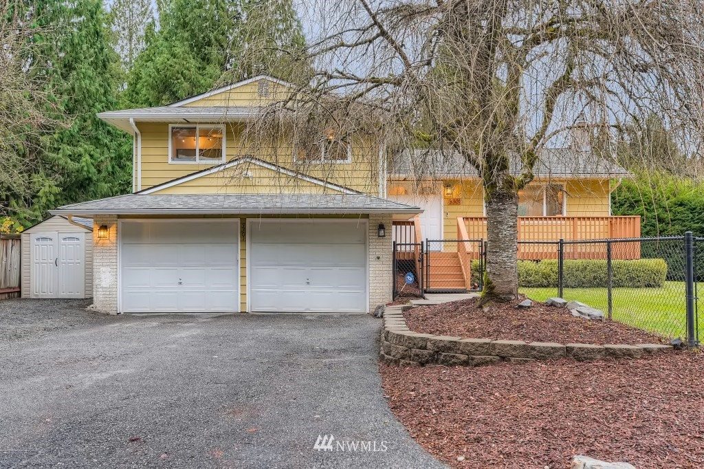 3301 198th Place Southeast Bothell, WA 98012 - Photo 3 of 35 a front view of a house with garage