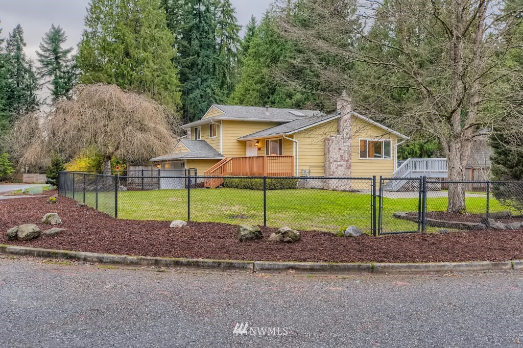 3301 198th Place Southeast Bothell, WA 98012 - Photo 33 of 35 a green field with some trees in the background