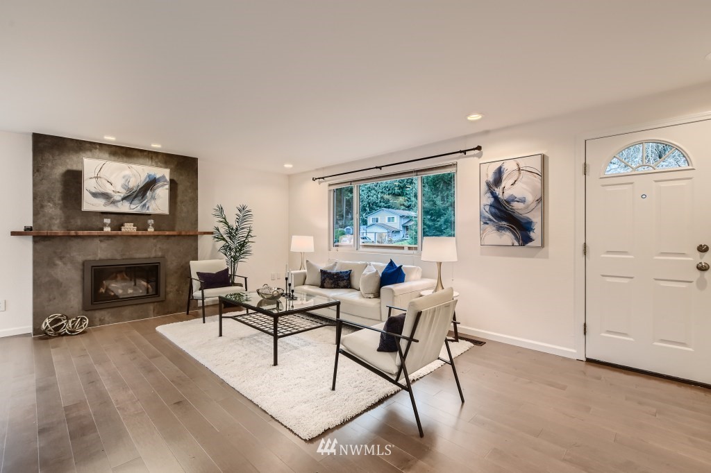 3301 198th Place Southeast Bothell, WA 98012 - Photo 6 of 35 a living room with furniture a fireplace and a large window