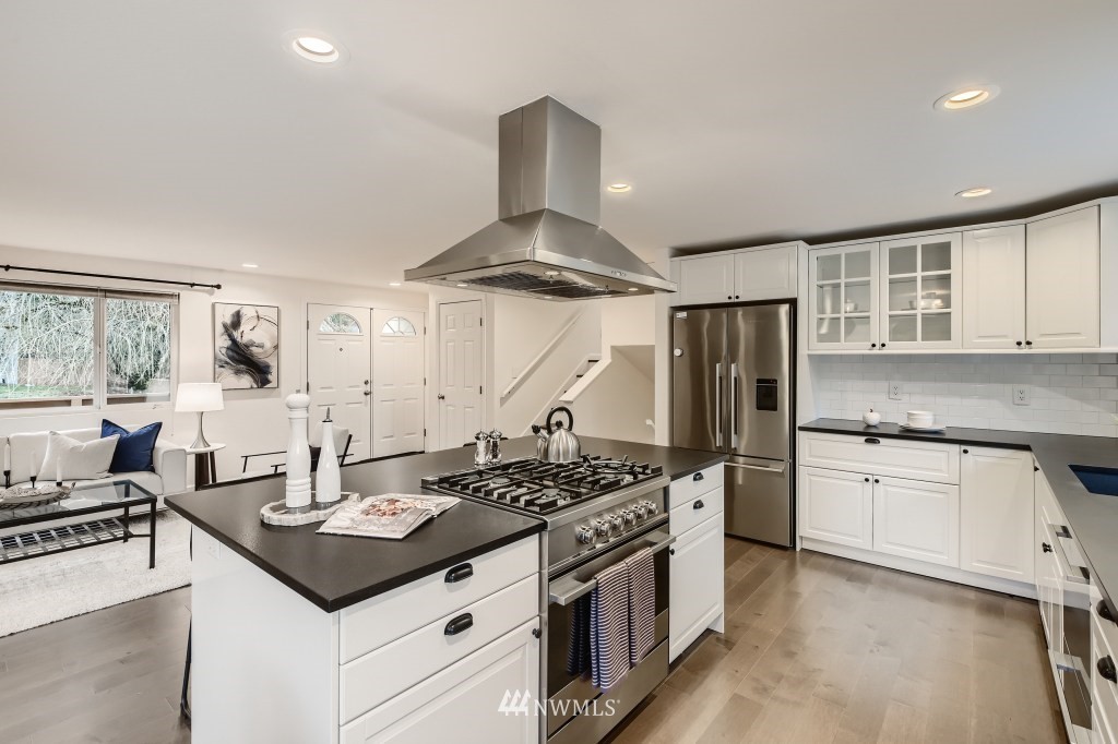 3301 198th Place Southeast Bothell, WA 98012 - Photo 10 of 35 a kitchen with stainless steel appliances granite countertop a sink stove and refrigerator