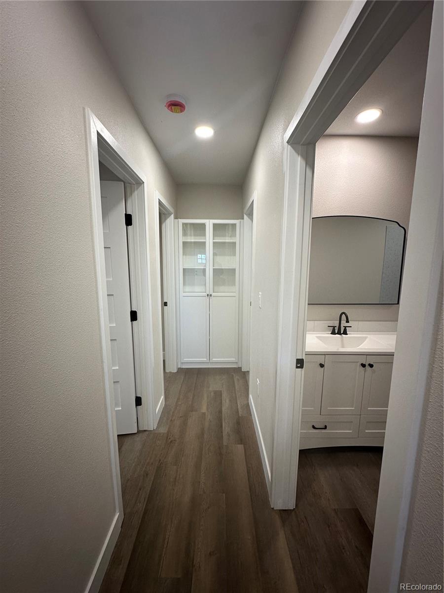 215 6th Street Hugo, CO 80821 - Photo 15 of 28 a bathroom with a sink and mirror